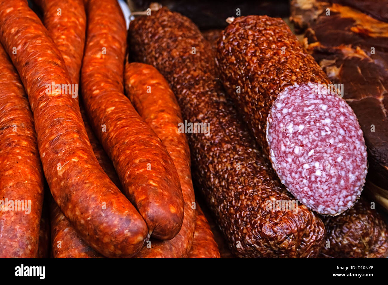 Sausages and salami cut, placed on a table Stock Photo Alamy