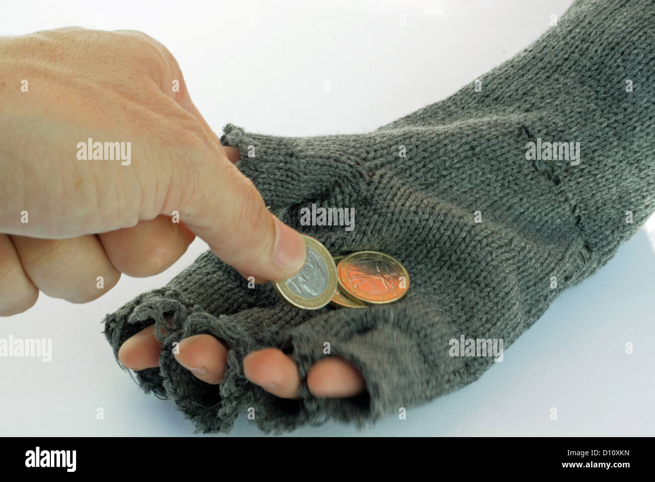 hand of a poor man who accepts little money to tip as alms for a living Stock Photo