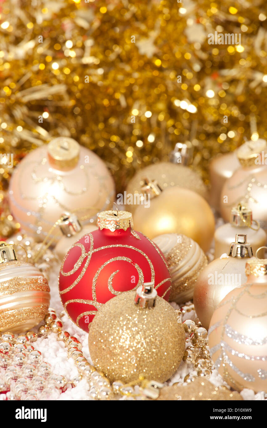 Red and gold Christmas baubles on golden background Stock Photo - Alamy