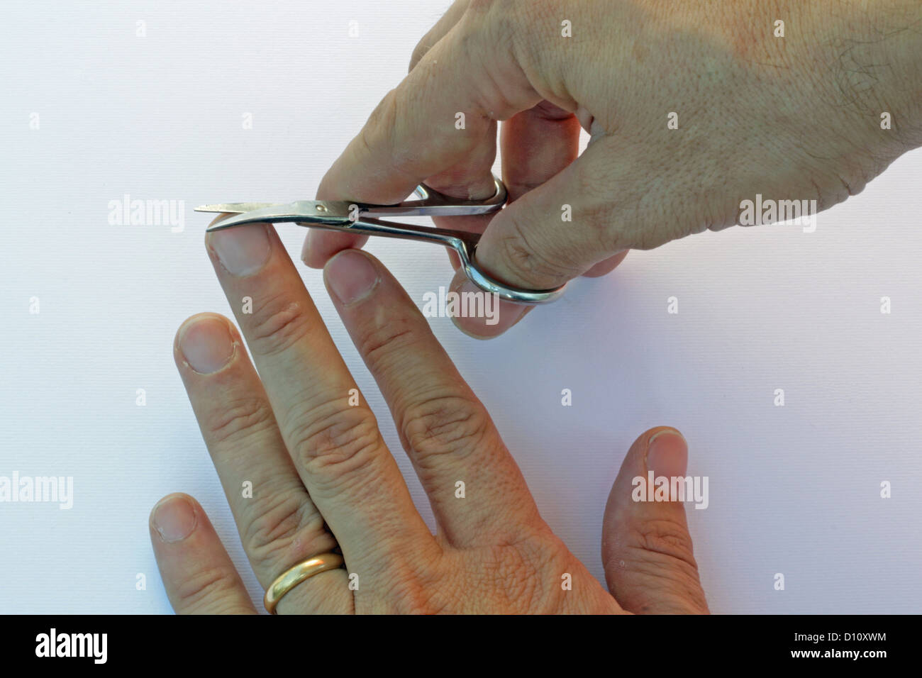 hand of a man who cuts the nails from manicure Stock Photo