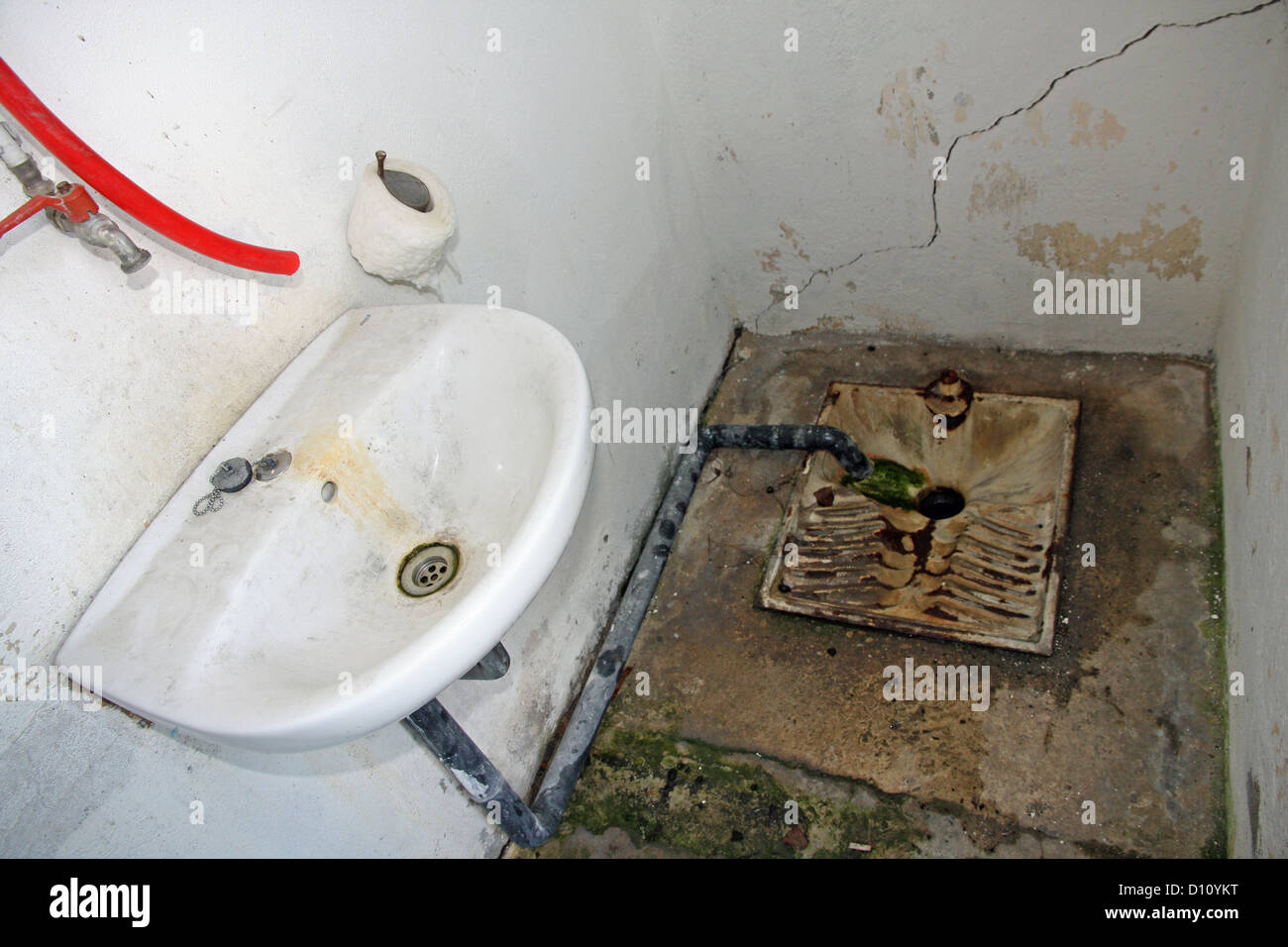 ruined and abandoned hygienic service in a dilapidated train station Stock Photo