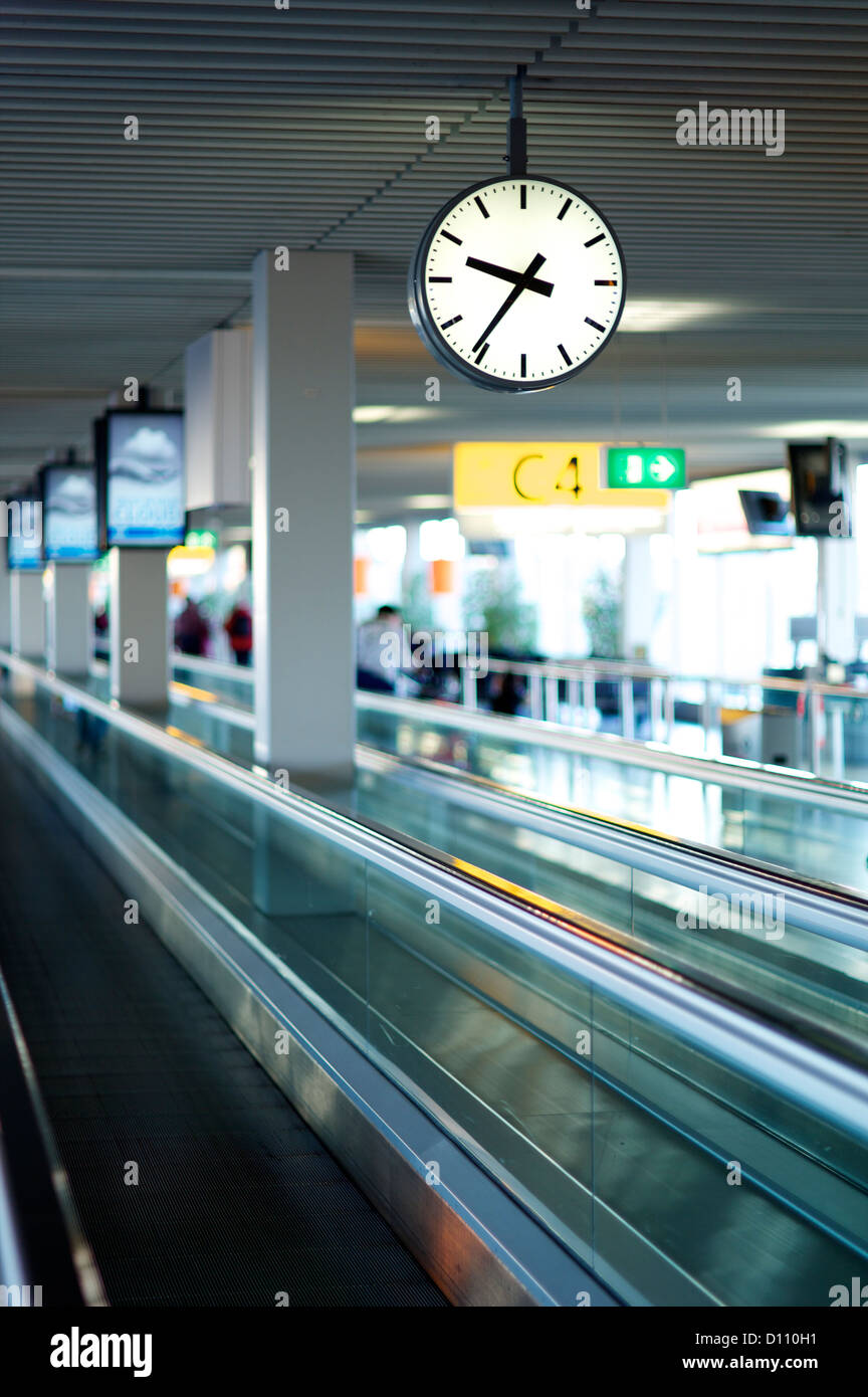 Conveyor belt in an airport with people in the distance Stock Photo