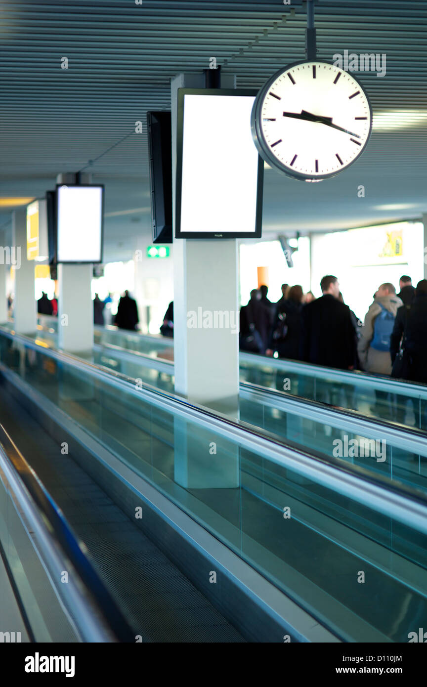 Airport conveyor belt with people in the distance Stock Photo