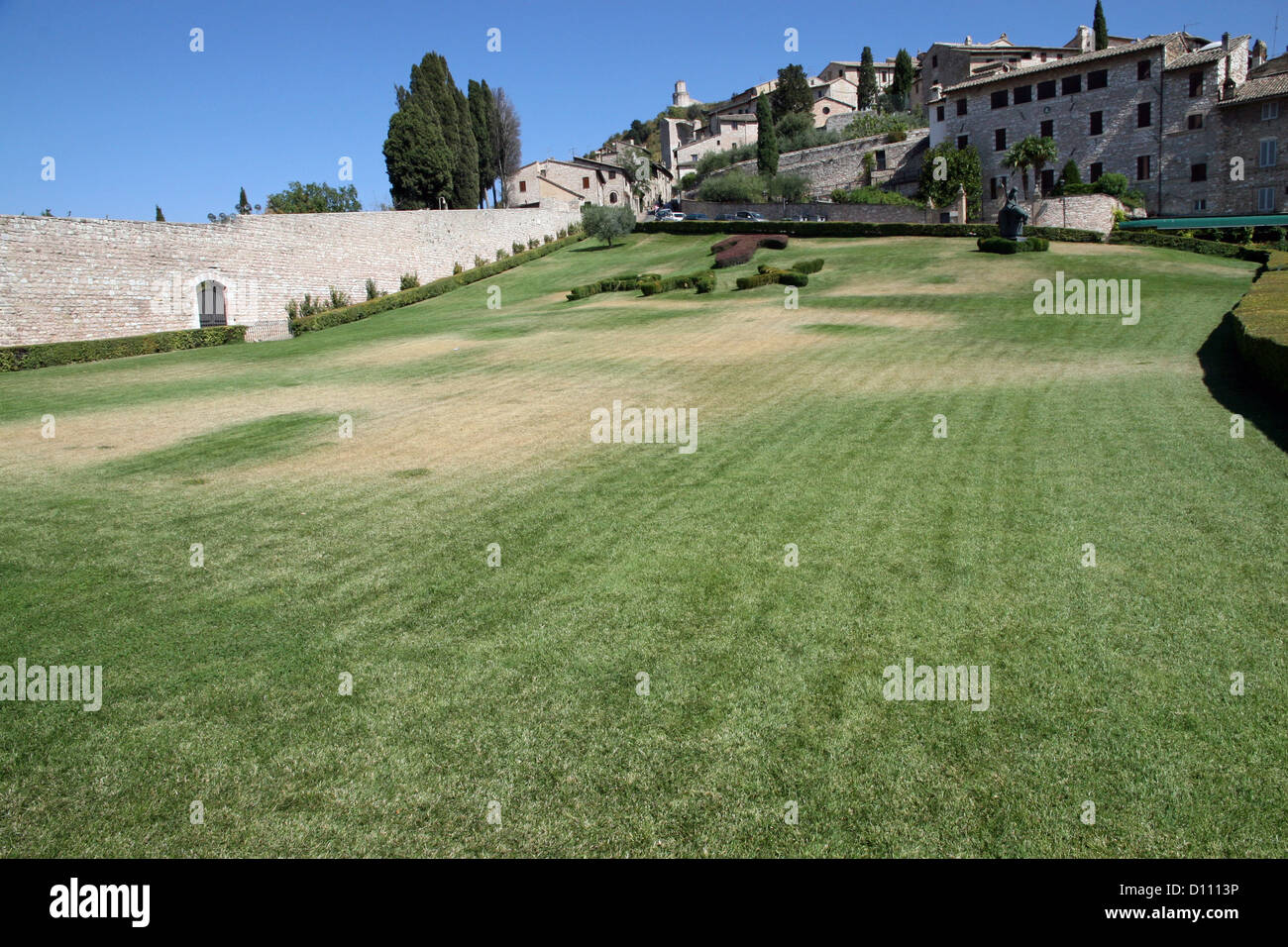 exceptional garden in front of the Basilica of Assisi with Tau and Pax in grass Stock Photo