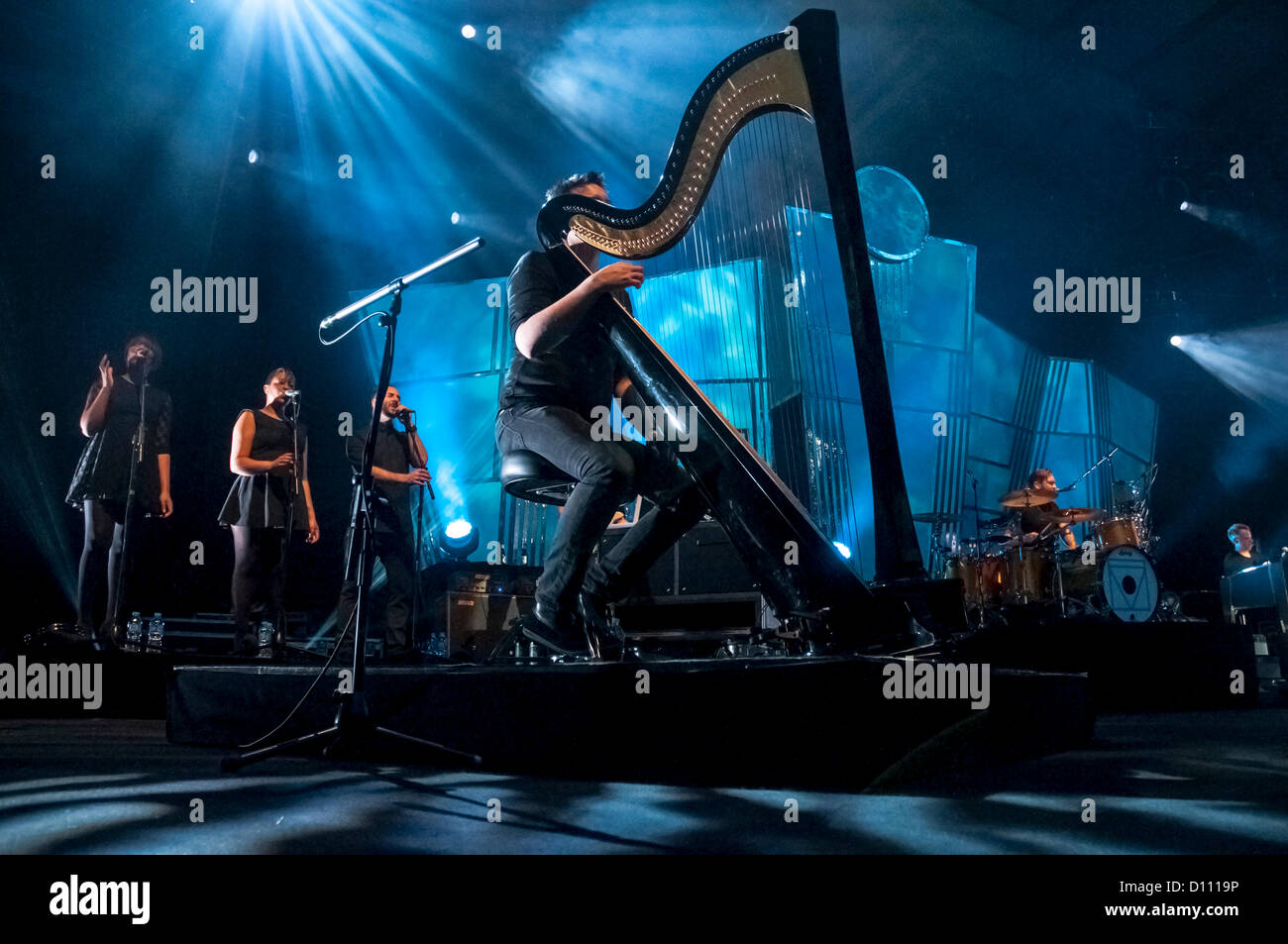 Exeter, Devon, UK. 4th December 2012. The harpist and the backing singers performing during the Florence And The Machine concert at the Exeter Westpoint Arena Credit:  Clive Chilvers / Alamy Live News Stock Photo
