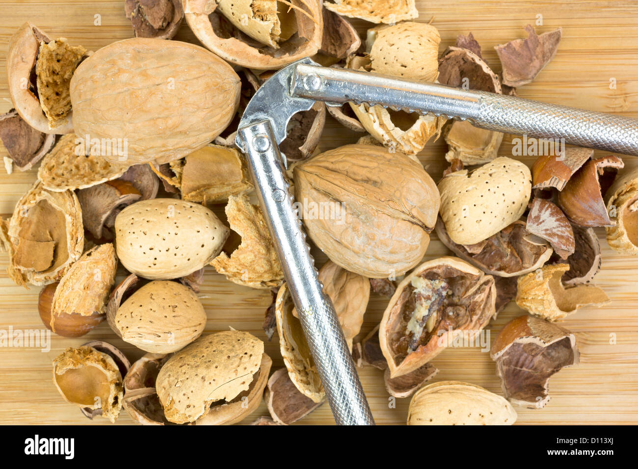 A close view of broken shelled nuts with whole almond, walnuts and