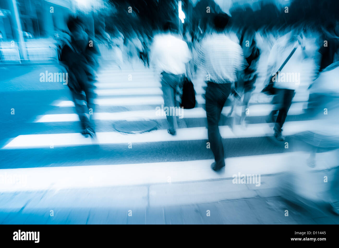 people walking on big city street, blurred motion zebra crossing abstract Stock Photo