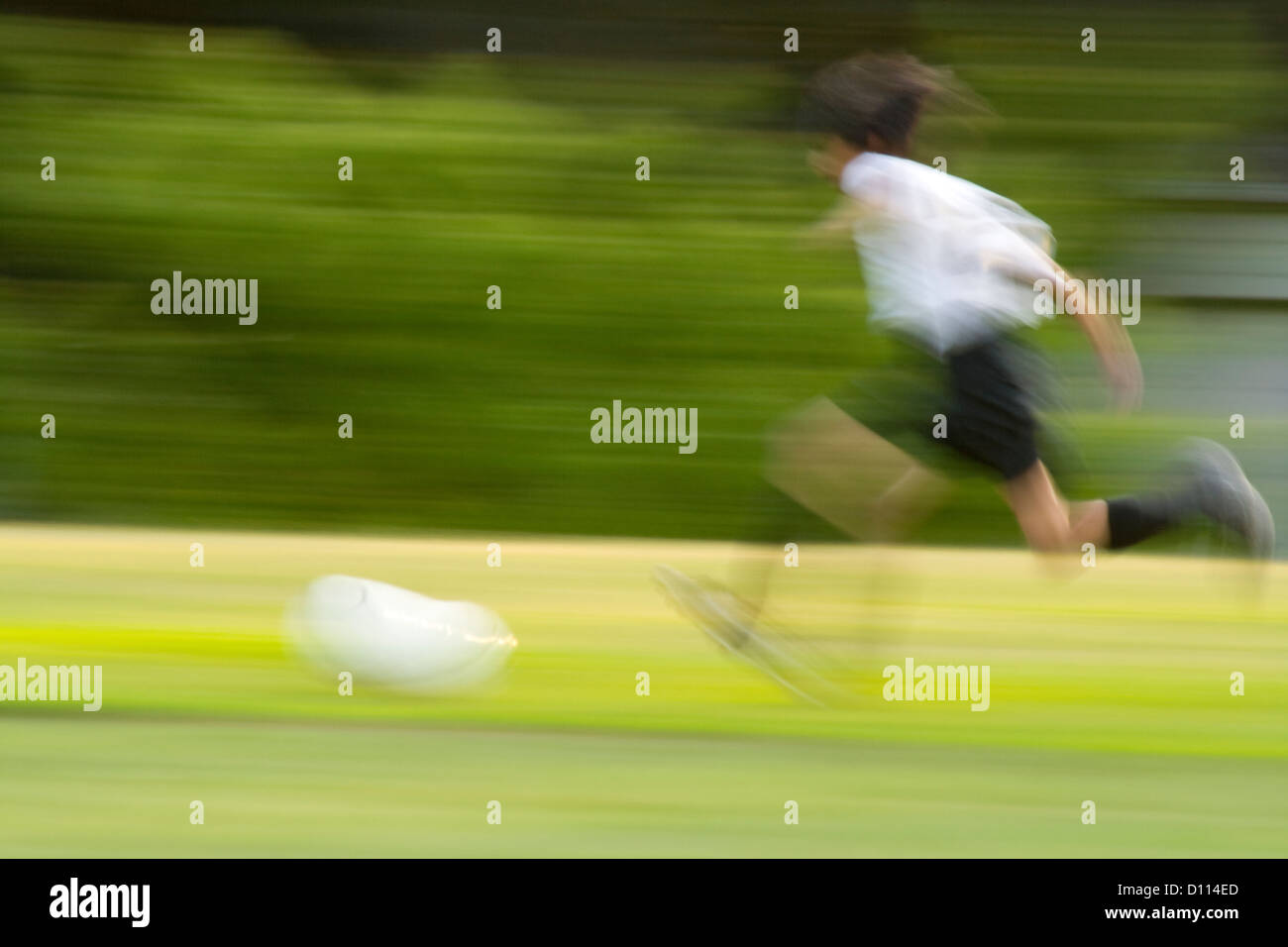 Blurred soccer player running with ball demonstrating the speed of the game. St Paul Minnesota MN USA Stock Photo