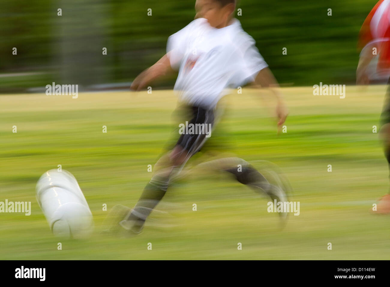 Blurred soccer player running with ball demonstrating the speed of the game. St Paul Minnesota MN USA Stock Photo