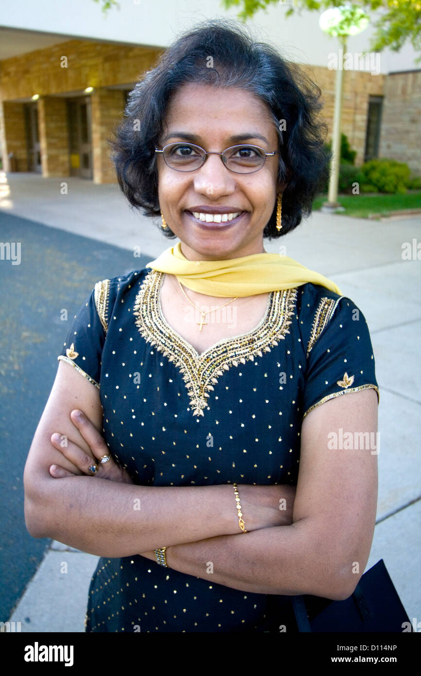 Happy East Indian American woman age 57 wearing an ethnic stylish dress at her sisters wedding. Minneapolis Minnesota MN USA Stock Photo