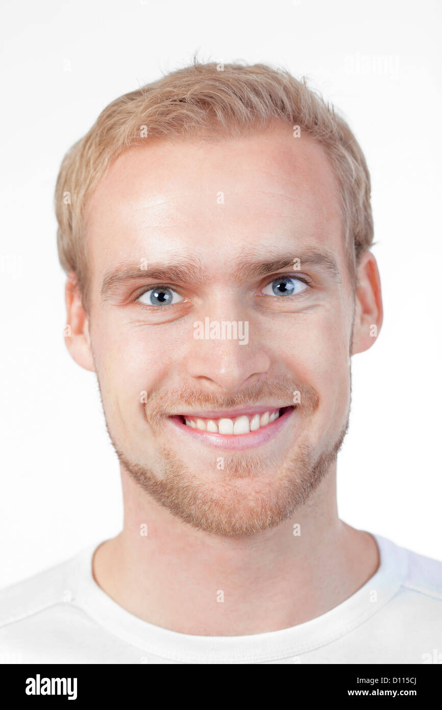 portrait of a young man with blond hair smiling - isolated on white ...