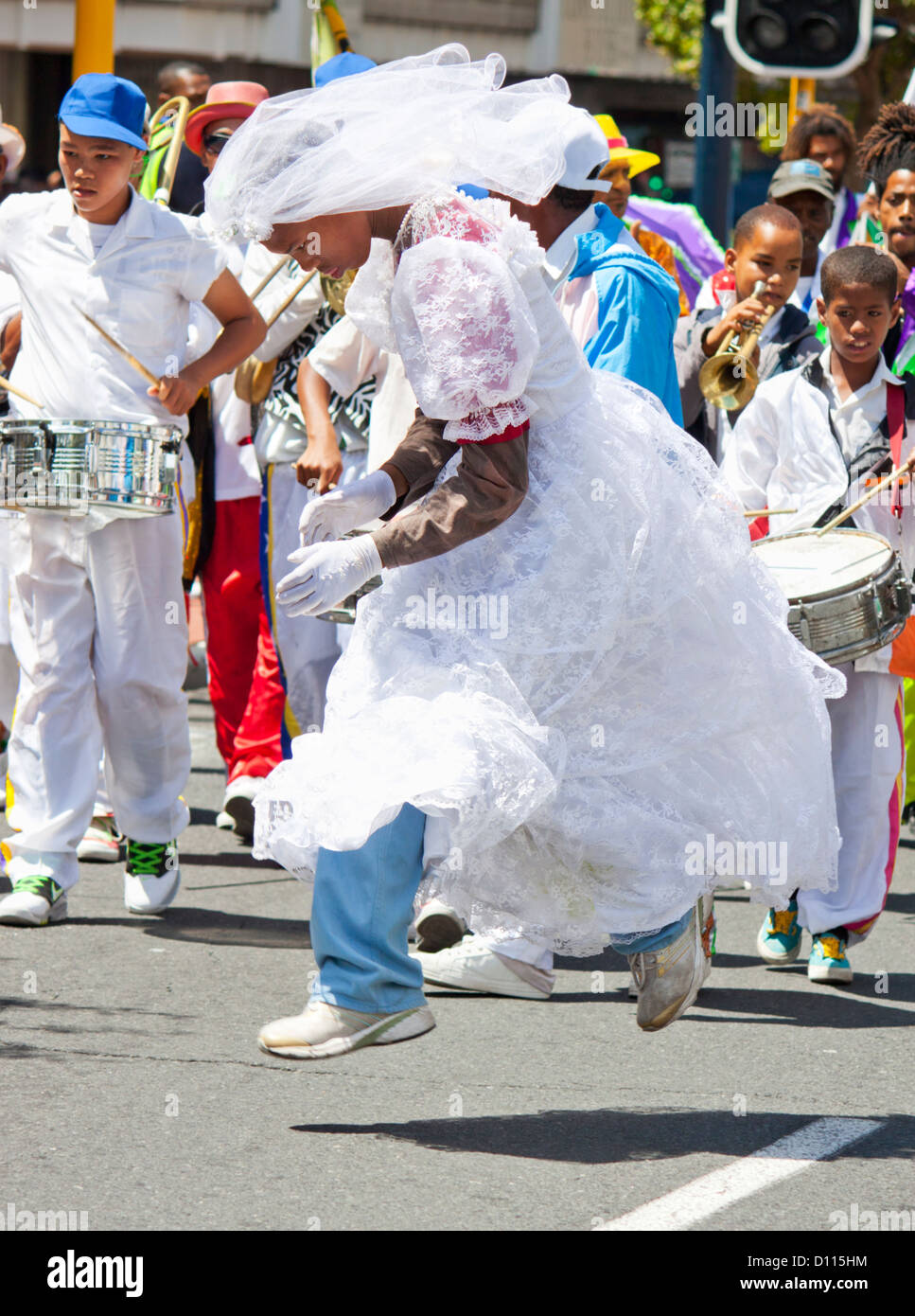 Man dressed as bride leaping to the beat of the carnival music Stock Photo