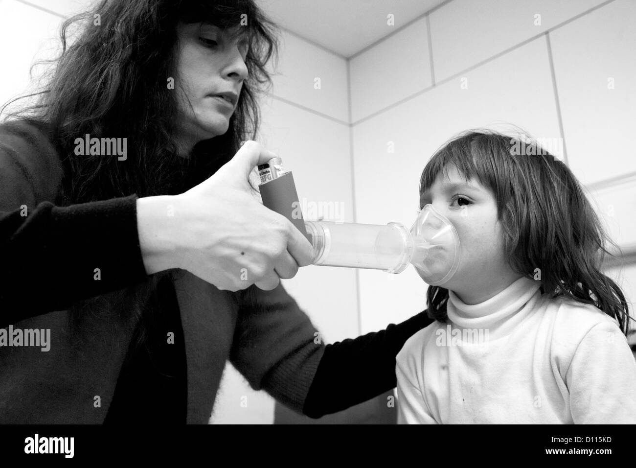 Mother giving her 4 year old son inhalation aerosol in hospital Stock Photo