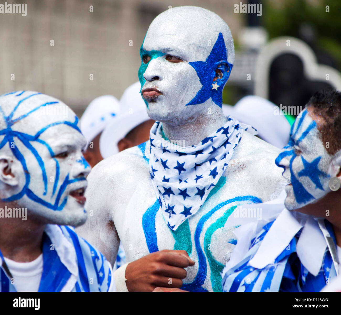 Men in carnival with painted silver and blue stars and stripes. Stock Photo