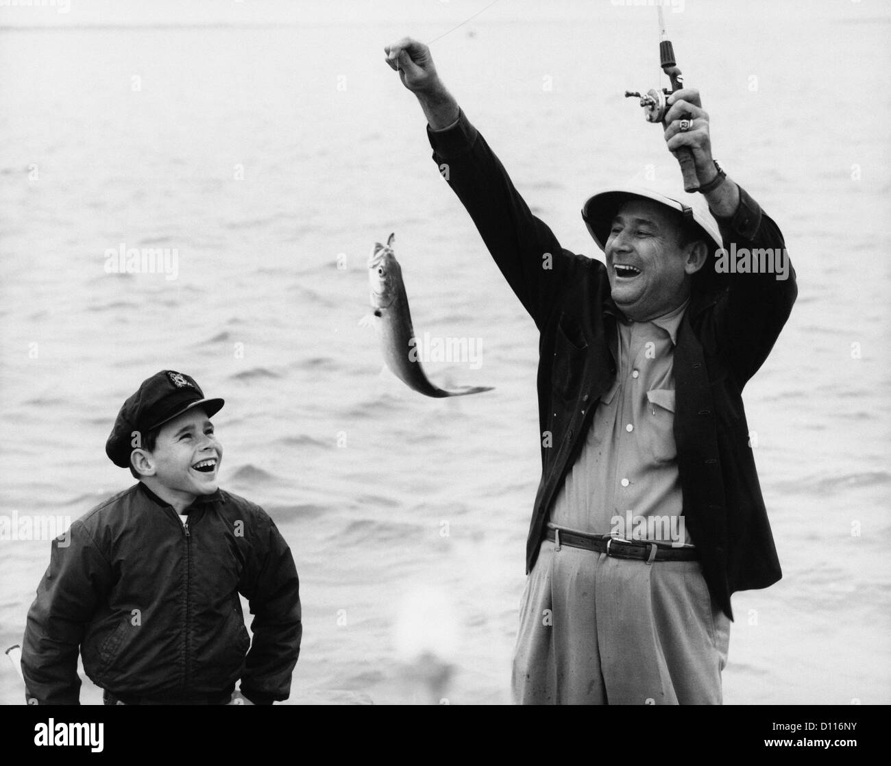 Men holding fishing rods Black and White Stock Photos & Images - Alamy