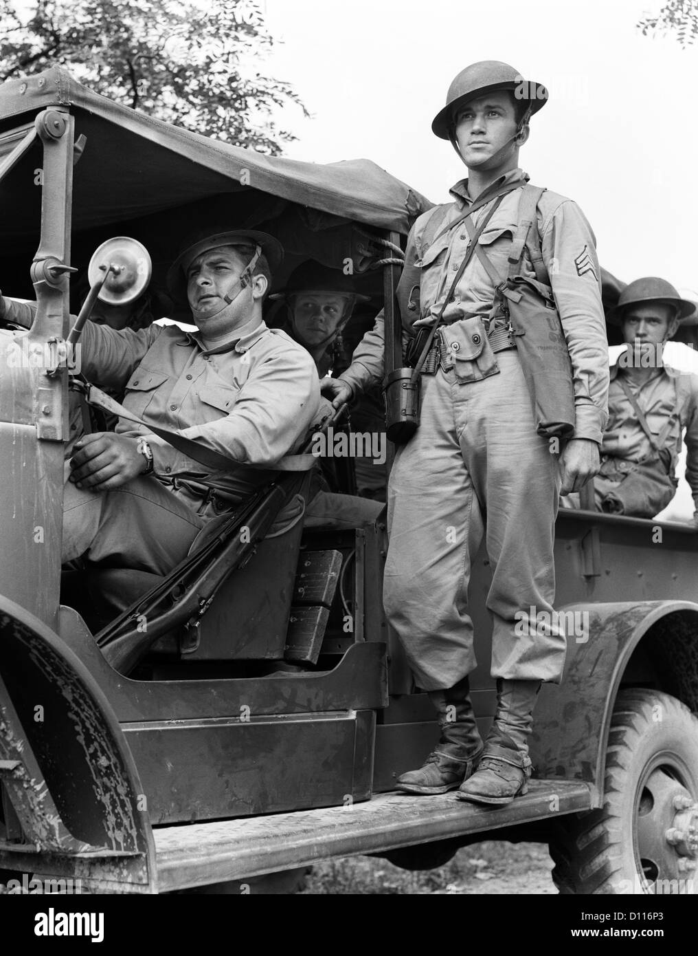 1940s US ARMY SOLDIERS RIDING ON MILITARY TRUCK Stock Photo