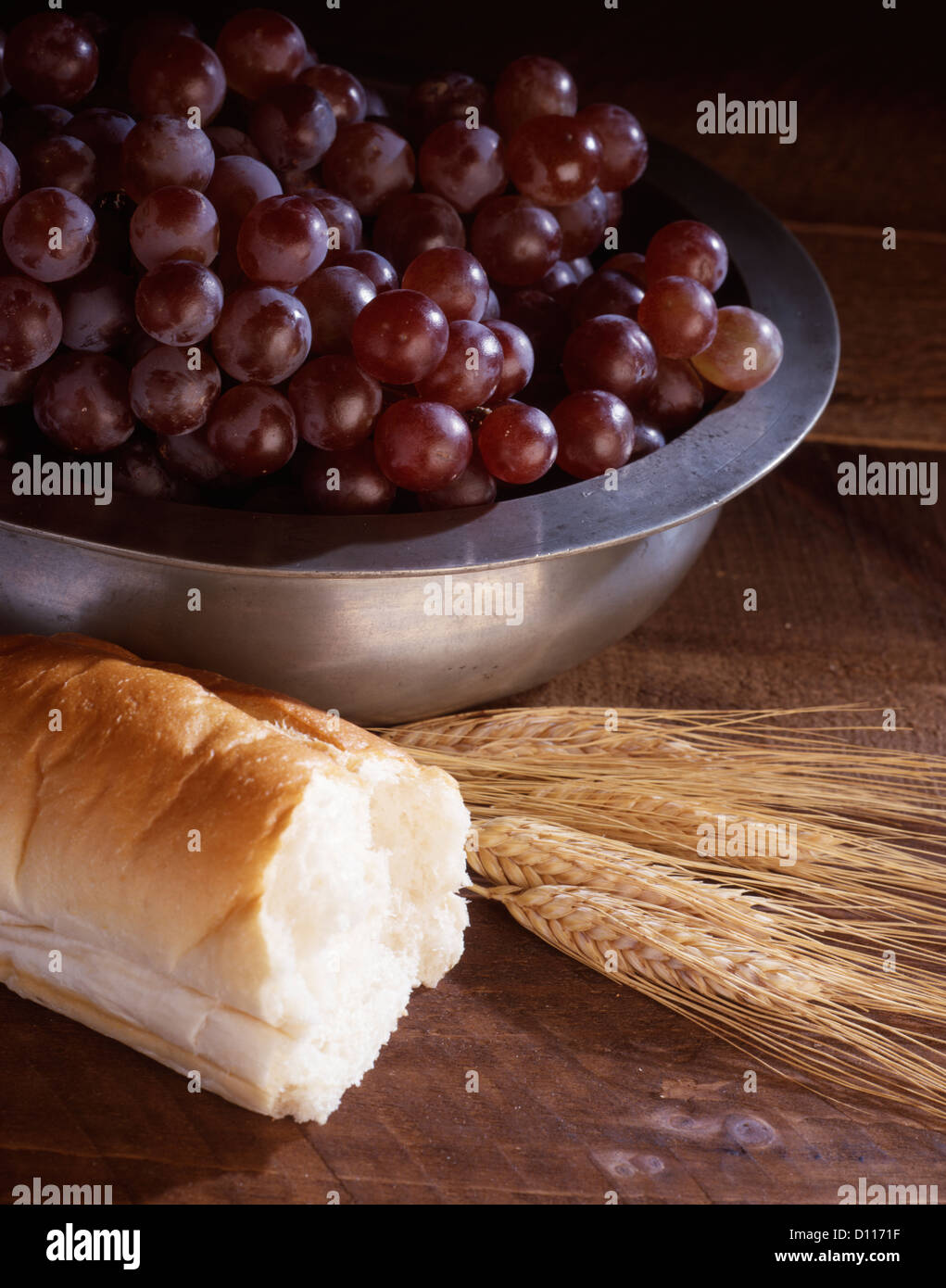 STILL LIFE OF WHEAT BREAD AND GRAPES IN A SILVER BOWL SYMBOLIC OF Stock