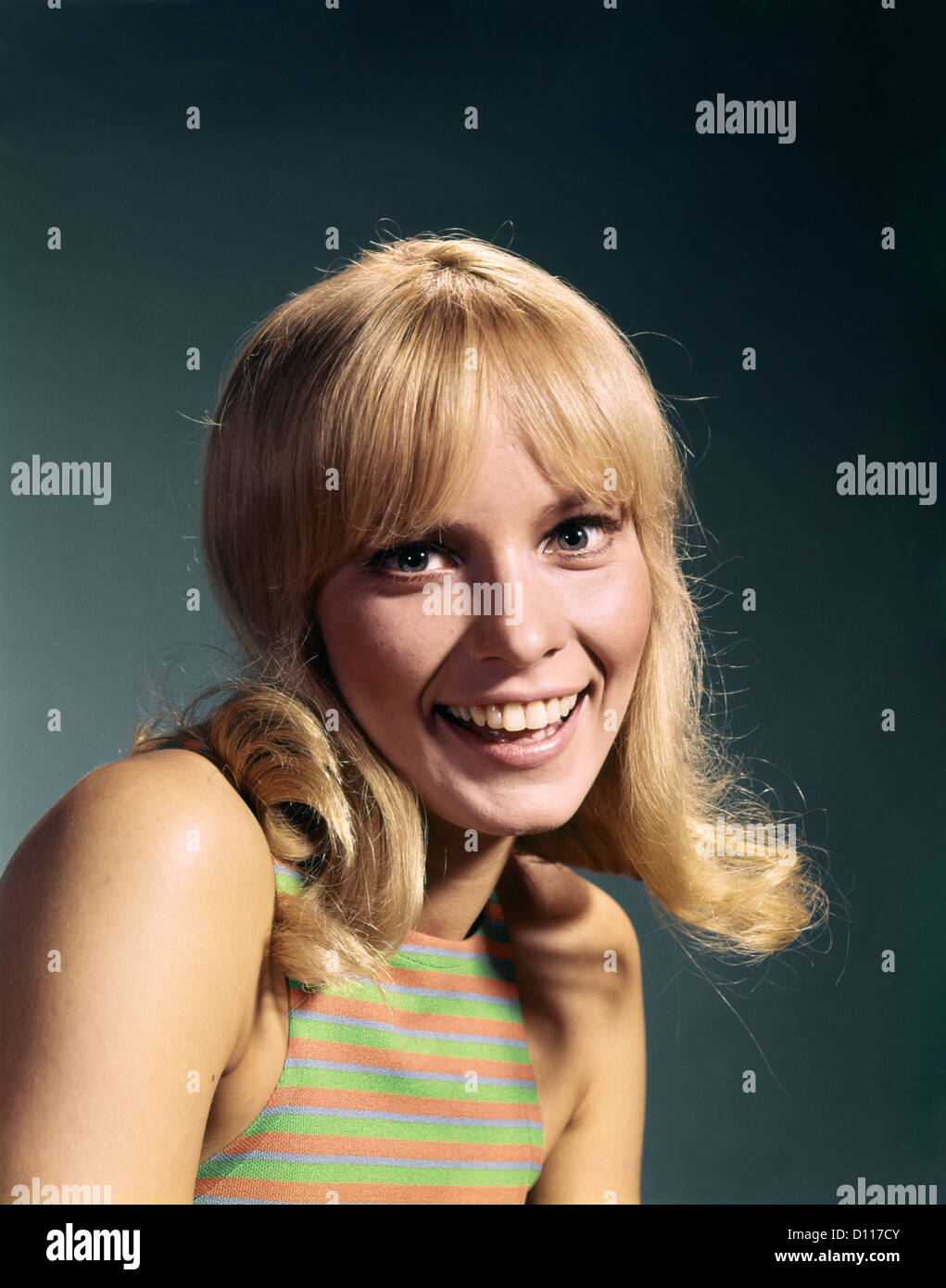 1960s PORTRAIT OF YOUNG BLOND WOMAN SMILING WEARING STRIPED SLEEVELESS TOP Stock Photo