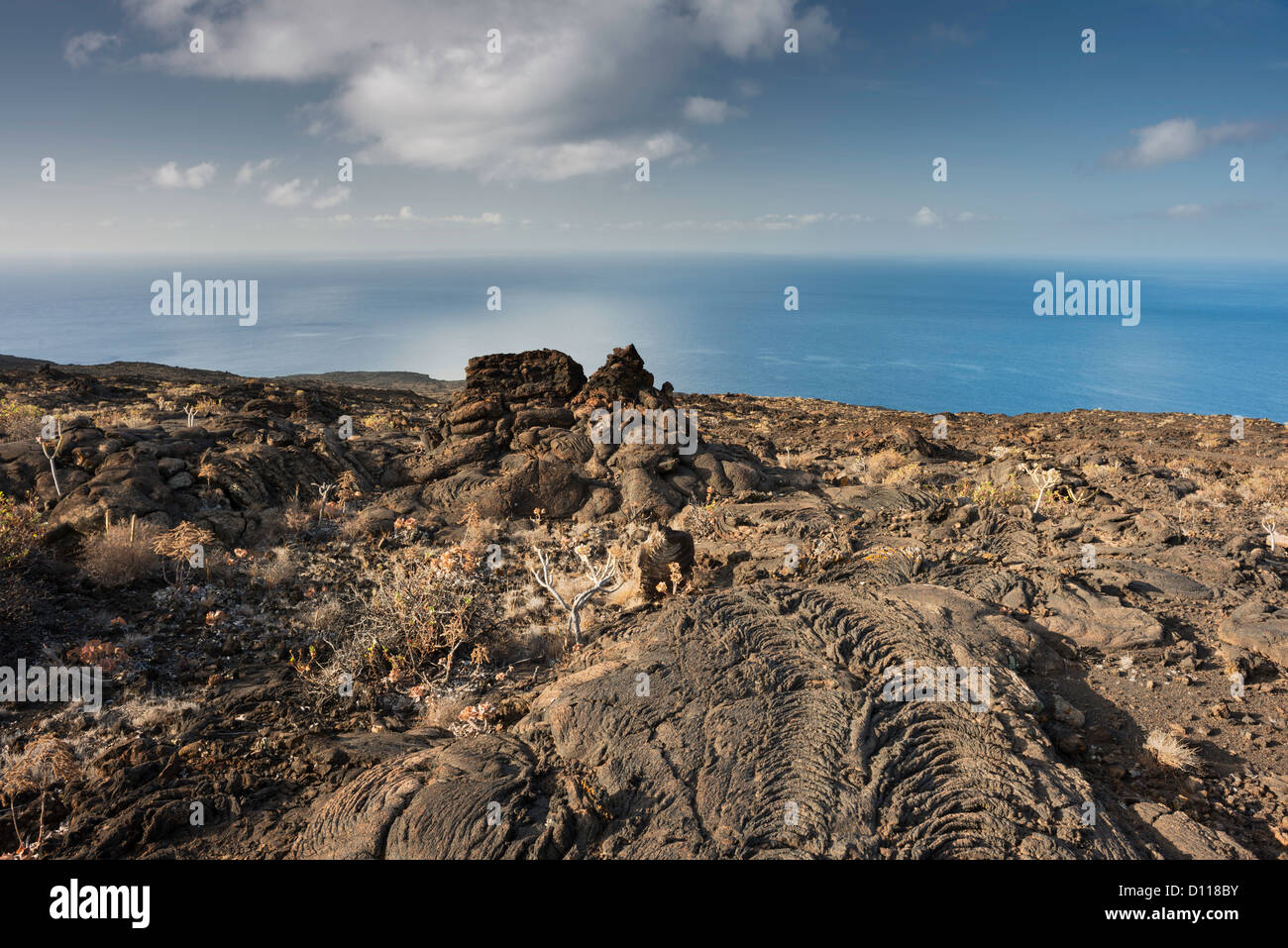 Pahoehoe lava field at Tacoron on south coast of El Hierro, Canary Islands, with Mar de las Calmas (Sea of Calm) in background Stock Photo