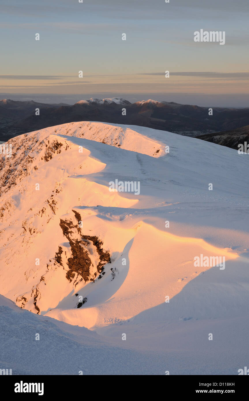 Dawn sunlight on the snow clad summit ridge of Blencathra in the English Lake District Stock Photo