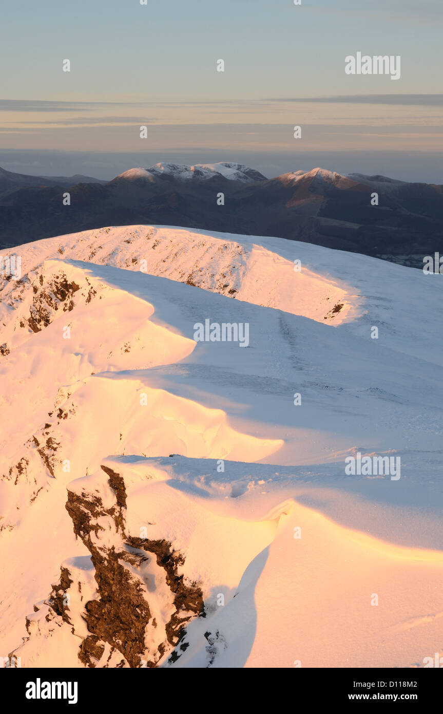Dawn sunlight on the snow clad summit ridge of Blencathra in the English Lake District Stock Photo