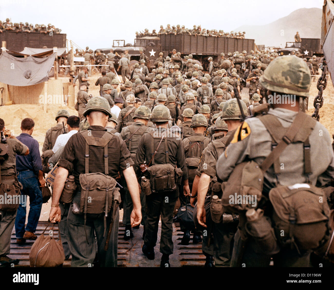 1960s 1965 ARRIVAL OF U.S. ARMY SOLDIERS IN VIETNAM 1ST CAVALRY DIVISION AIRMOBILE AS THEY LAND ON BEACH Stock Photo