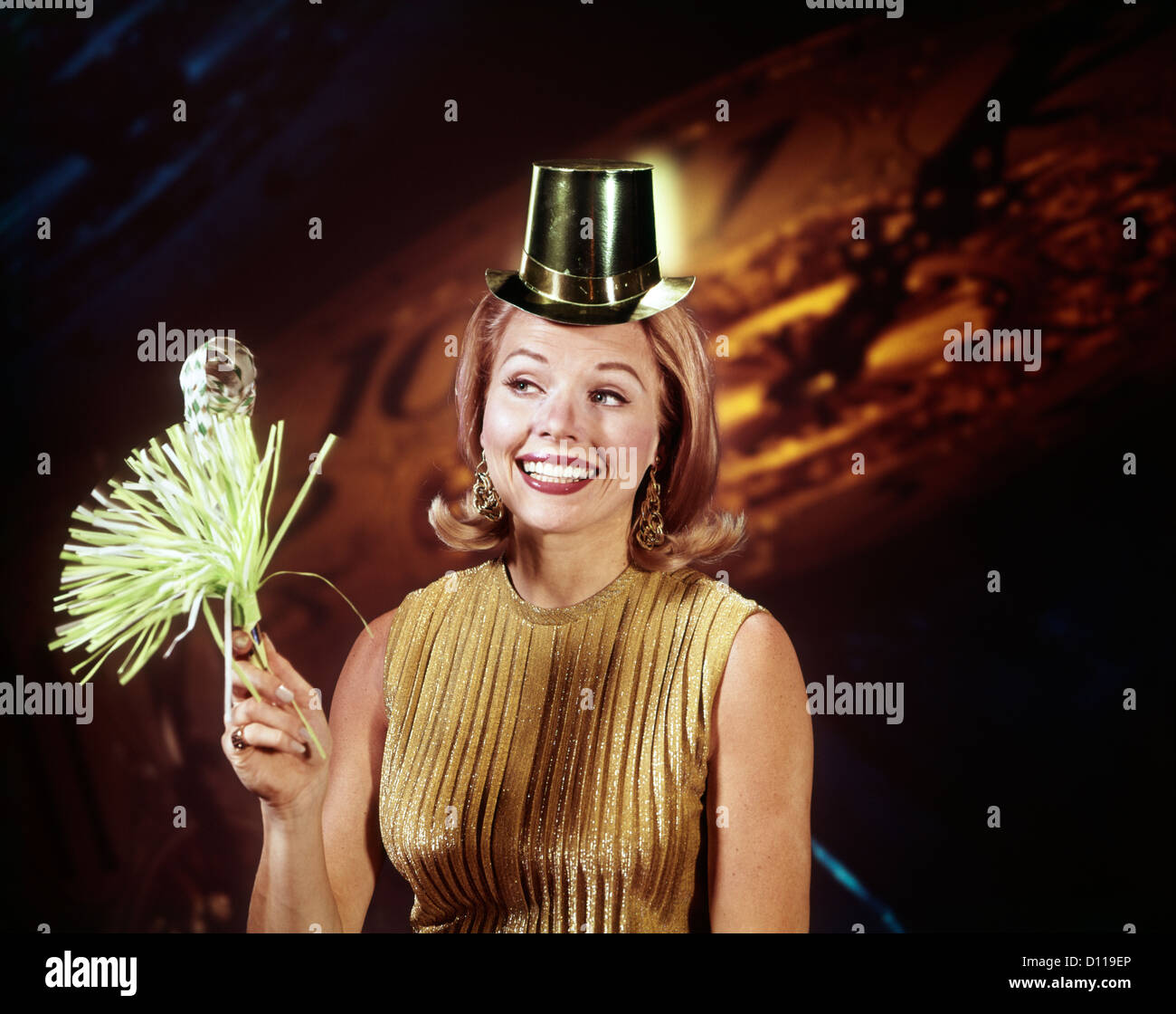 1960s YOUNG BLONDE WOMAN PARTY HAT NOISEMAKER HORN SMILING NEW YEAR CLOCK BACKGROUND Stock Photo