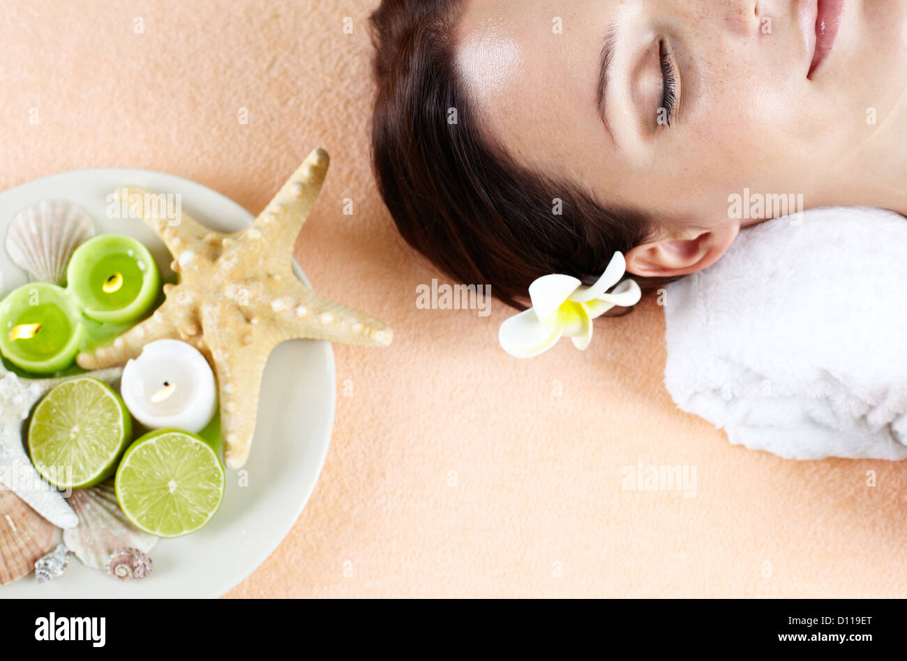 Close-up of a lovely woman lying in spa salon with her eyes closed ...