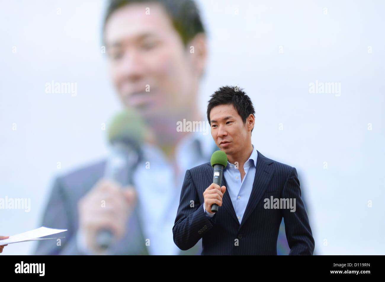 Japanese racing driver Kamui Kobayashi speaks during a special appearance at Hanshin racecourse in Japan on 2nd December, 2012. Stock Photo