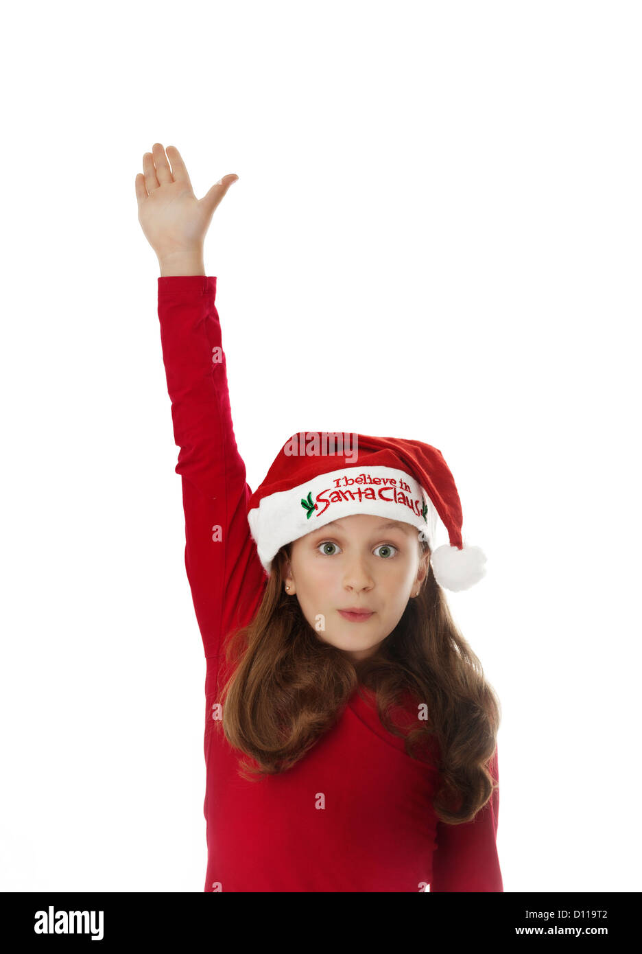young girl wearing Christmas Santa hat, posing Stock Photo Alamy