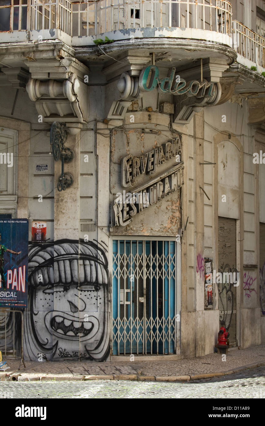 A disused Art Deco restaurant and Odeon in a side street in Lisbon, Portugal. With some graffiti on the wall. Stock Photo