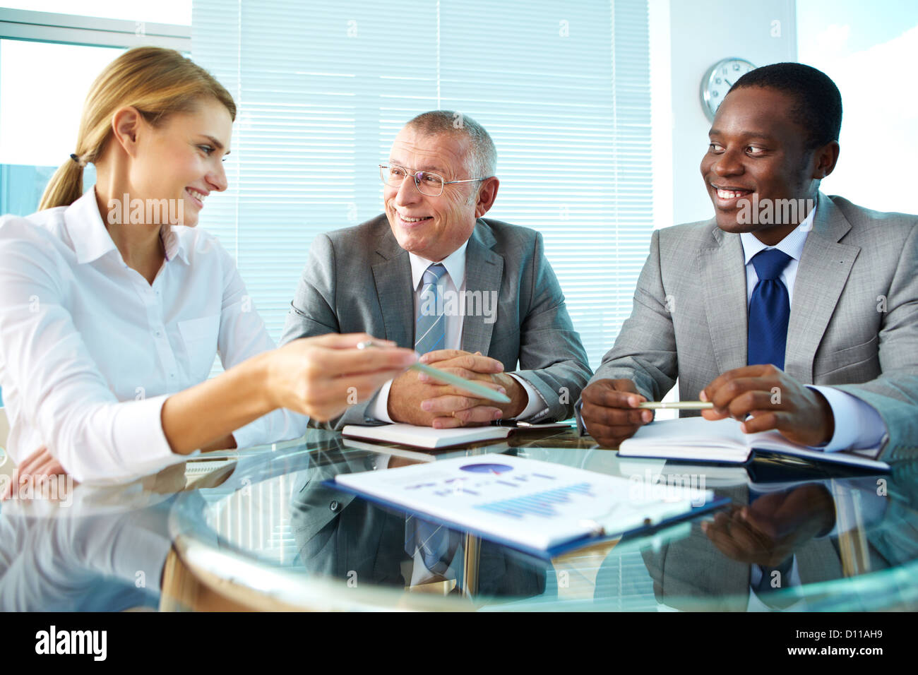 Portrait of pretty secretary pointing at paper while explaining ...