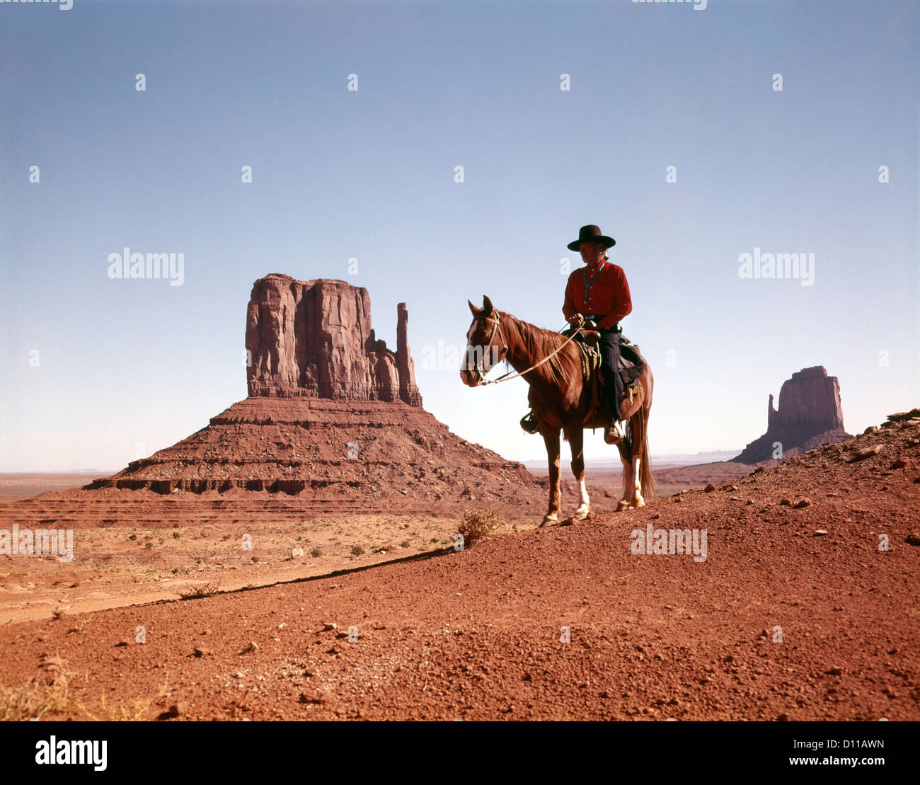 1960s NAVAJO MAN ON HORSE MONUMENT VALLEY NAVAJO TRIBAL RESERVATION USA Stock Photo