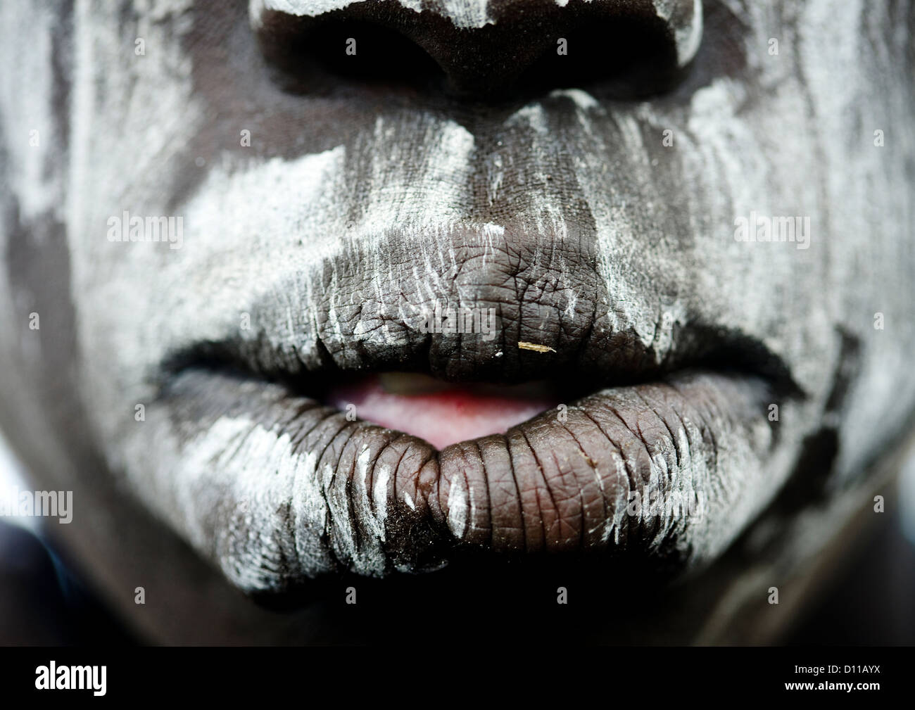 Close Up On A Mursi Tribe Woman Mouth With Face Paint In Mago National Park, Omo Valley, Ethiopia Stock Photo
