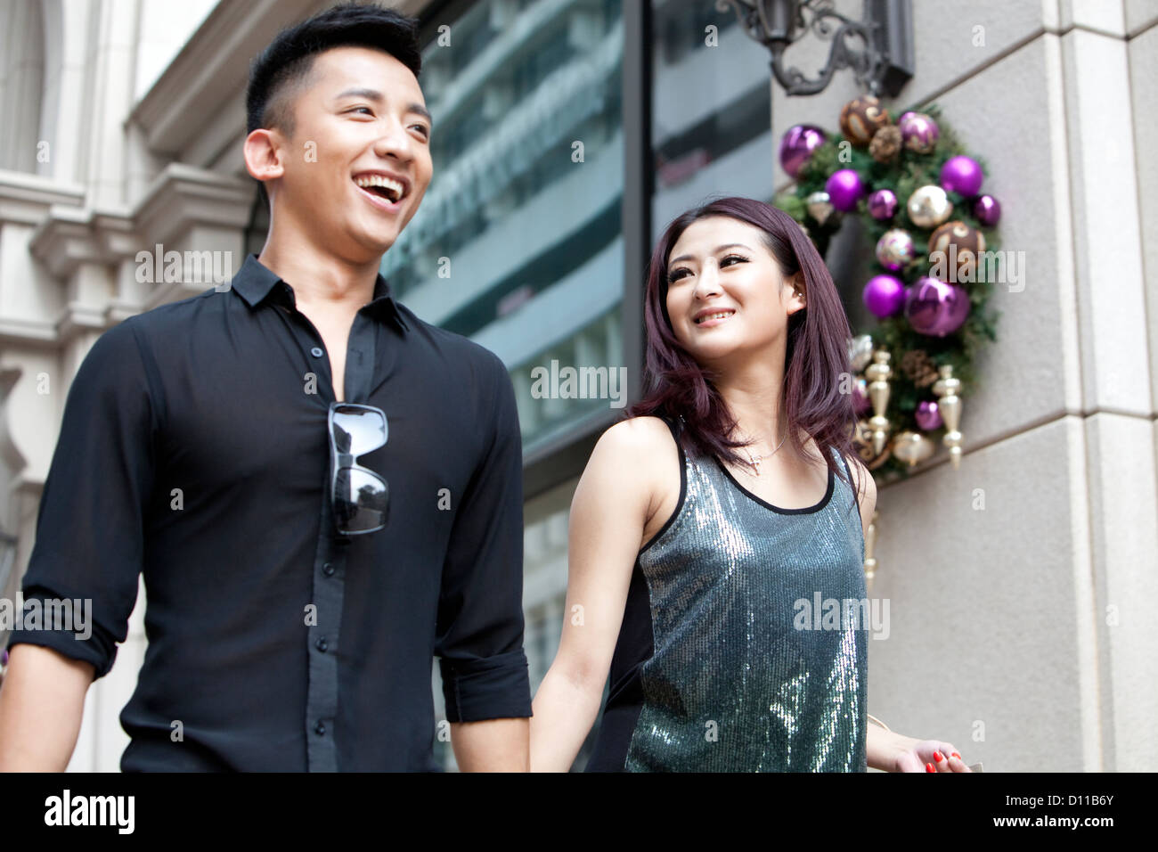 Happy young couple walking in the street, Hong Kong Stock Photo - Alamy