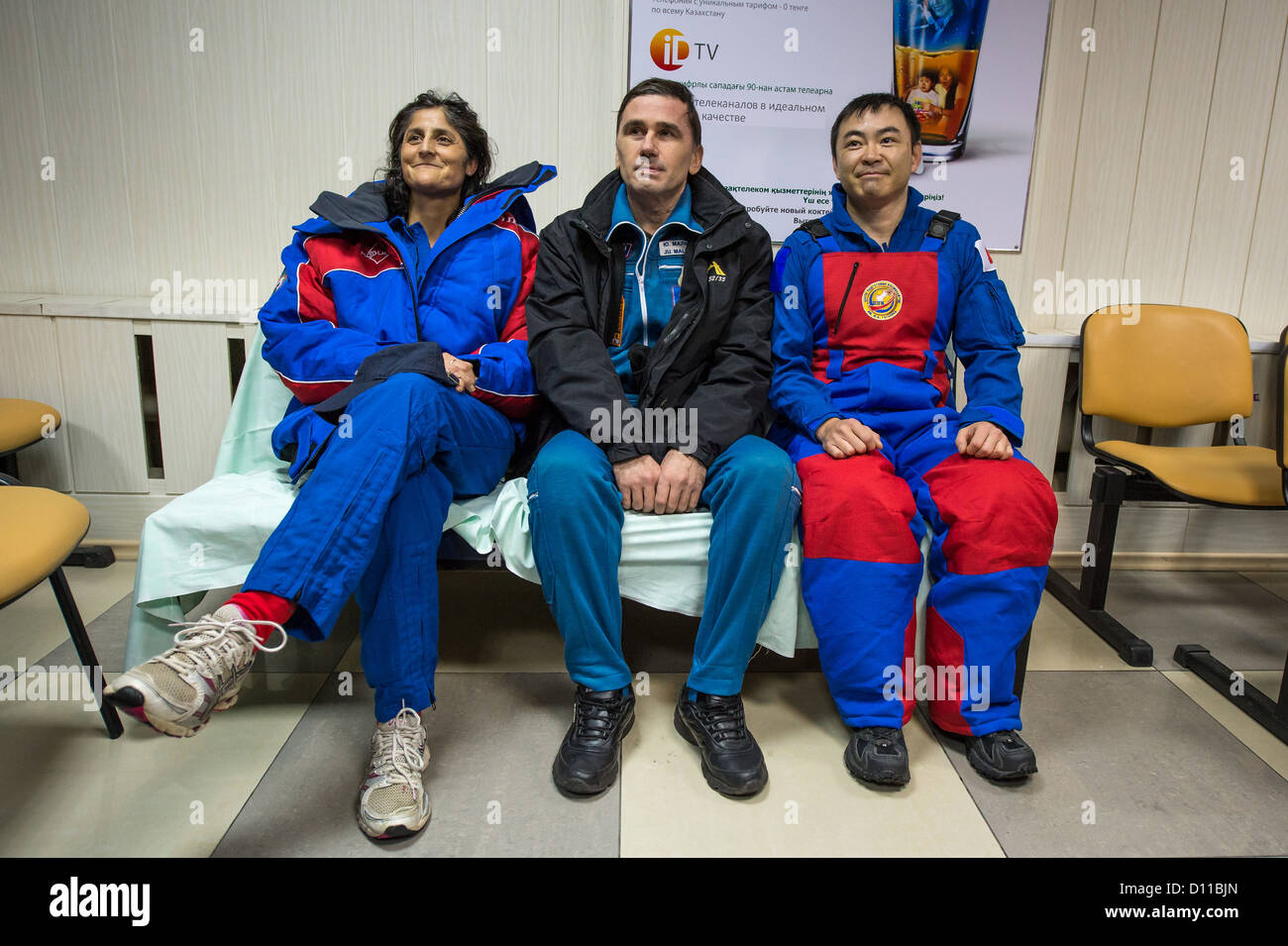 Expedition 33 crew members Commander Sunita Williams of NASA, Flight Engineers Yuri Malenchenko of ROSCOSMOS (Russian Federal Space Agency) and Akihiko Hoshide of JAXA (Japan Aerospace Exploration Agency) smile for photos at the Kustanay Airport in Kazakhstan a few hours after they landed their Soyuz spacecraft in a remote area outside the town of Arkalyk, Kazakhstan November 19, 2012. Williams, Hoshide and Malenchenko returned from four months onboard the International Space Station. Stock Photo