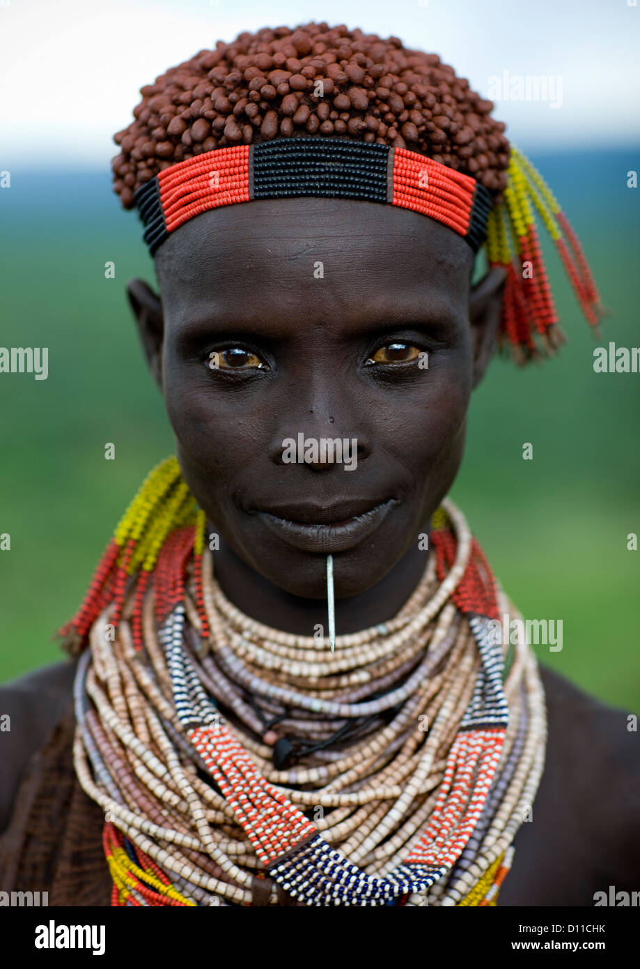 Portrait Of A Karo Woman With White Face Paint A Beaded Headband And A  Wooden Toothpick Sticking Through Her Chin Stock Photo - Download Image Now  - iStock