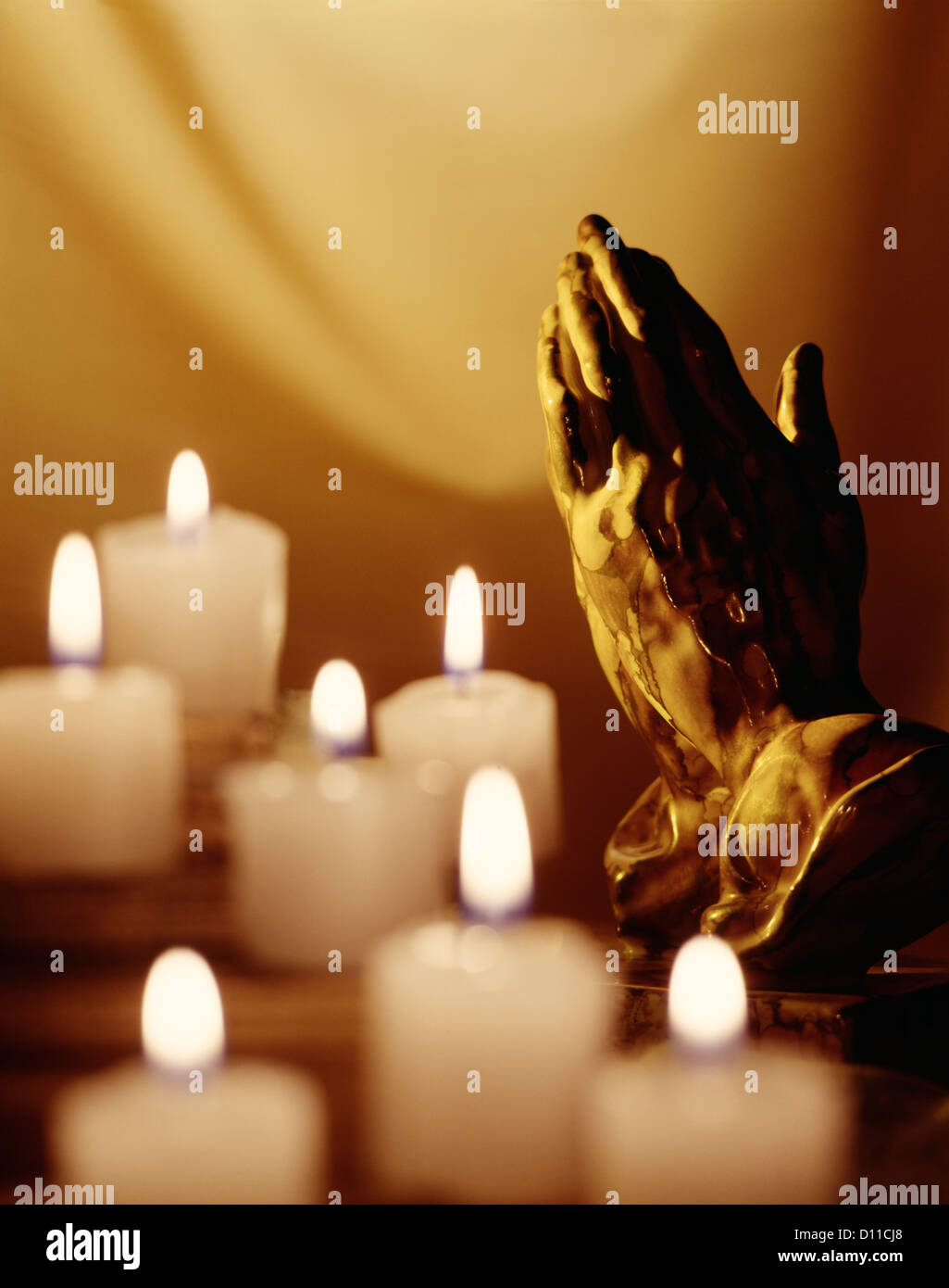PRAYING HANDS WITH CANDLES Stock Photo Alamy