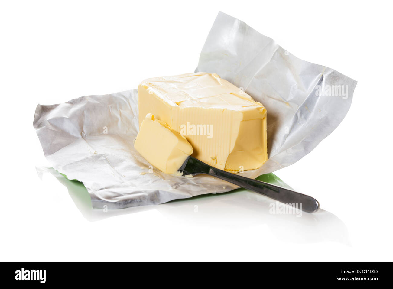 Block of butter in paper. Piece of butter is cut with a knife Stock Photo Alamy