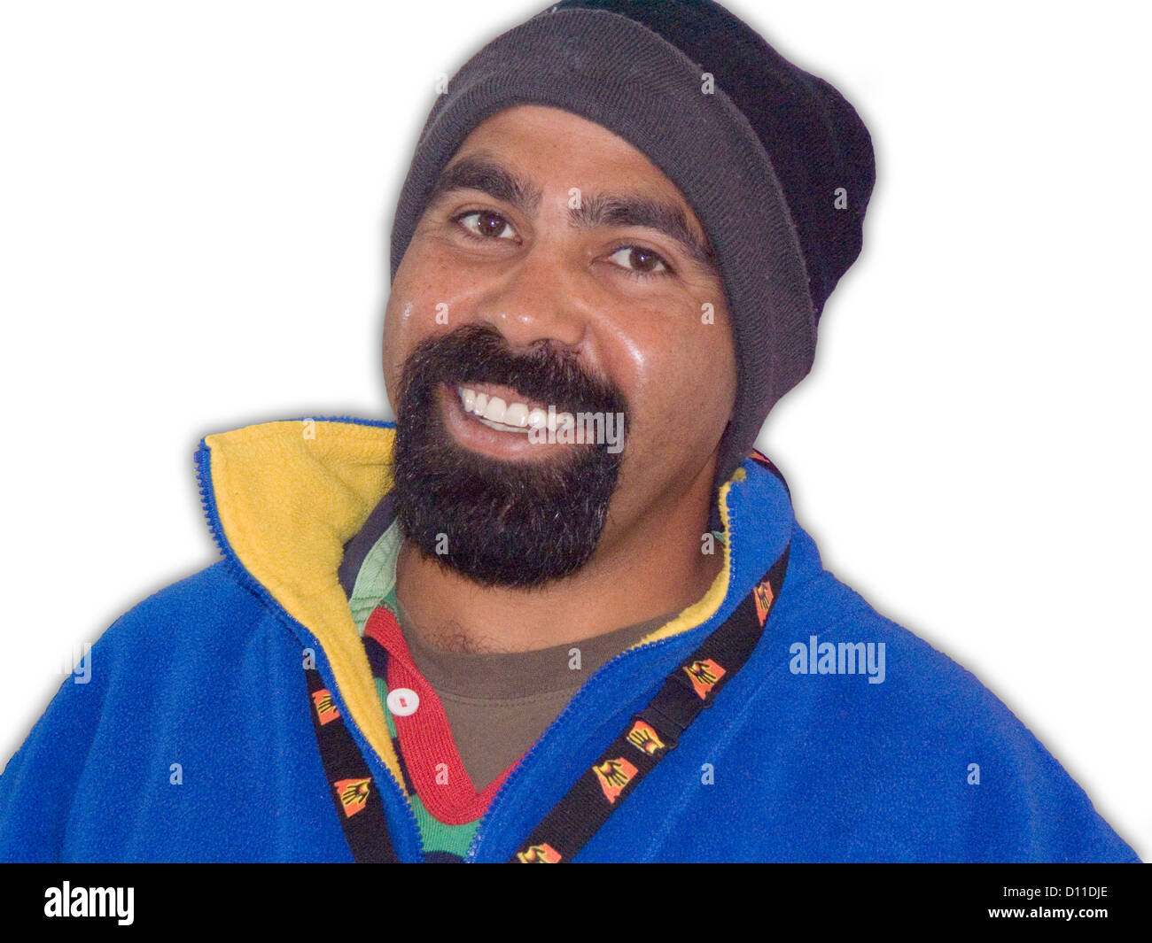 Australian aboriginal man with smiling face and beard wearing brightly  coloured jacket and woollen hat, against white background Stock Photo -  Alamy