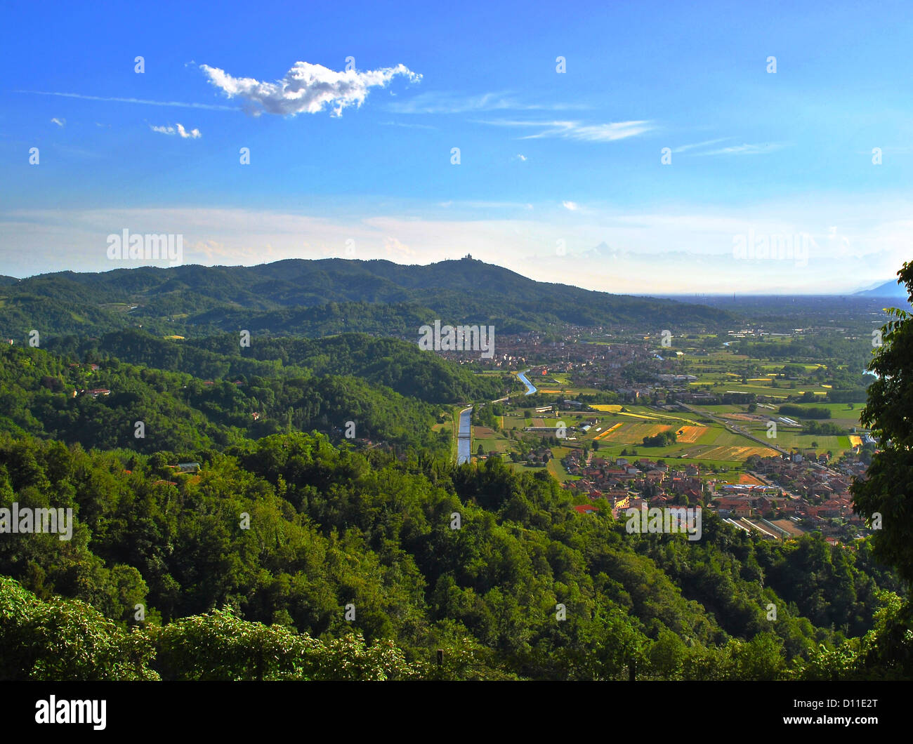 A view of the northern-east side of Turin hills in a sunny day with Superga church and Monviso Alps mountain background. Stock Photo