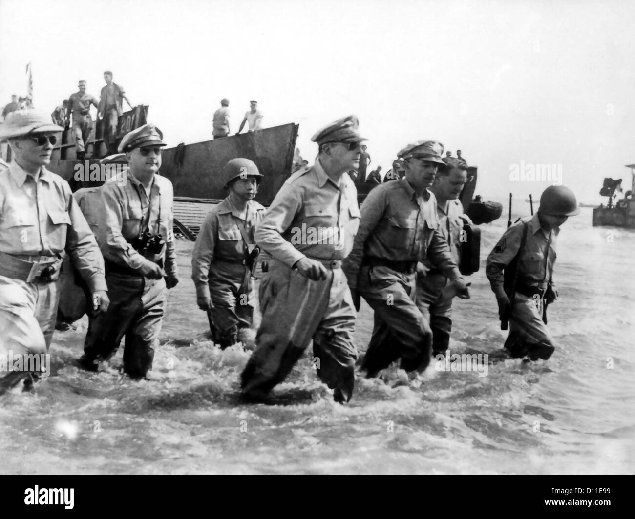 US General Douglas MacArthur (center) wades ashore during initial landings October 20, 1944 at Leyte, Philippine Islands. Stock Photo