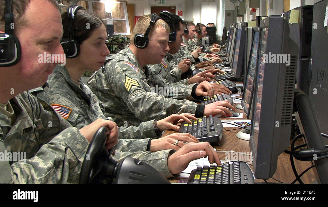 A squad of soldiers learn communication and decision making skills during virtual missions at the Grafenwoehr Training Area September 27, 2010 in Bavaria, Germany. Stock Photo