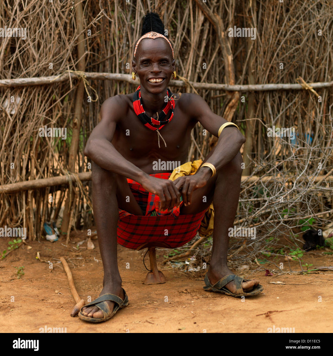 Portrait Of Smiling Hamar Tribe Man Sitting On Headrest In Turmi, Omo Valley, Ethiopia Stock Photo