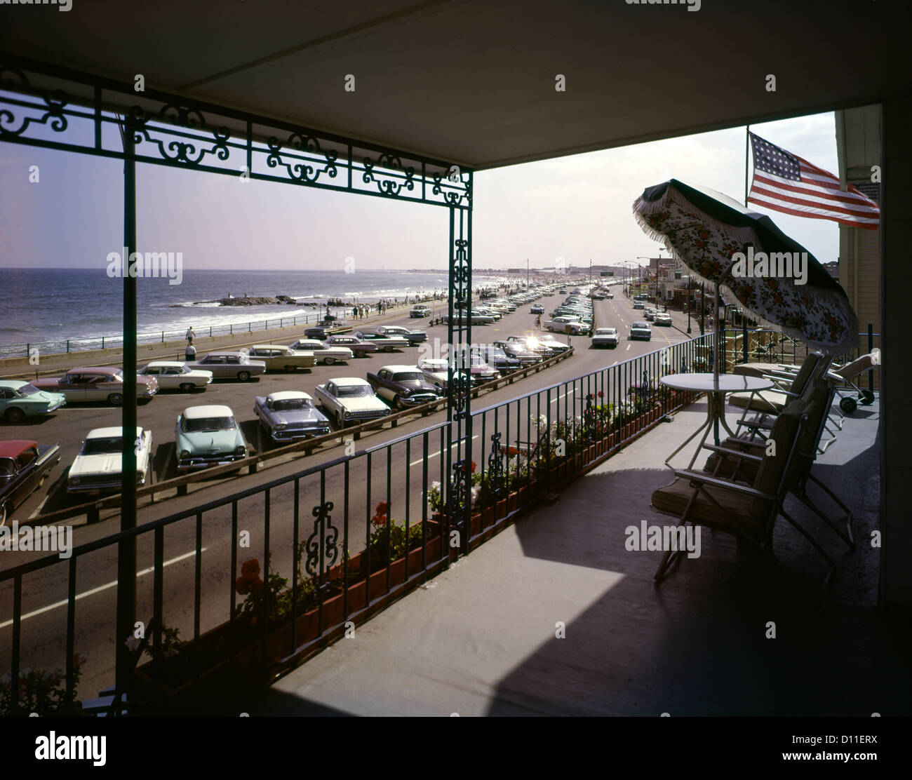 1960s VIEW FROM PATIO BALCONY OF HOTEL MOTEL CARS IN PARKING LOT
