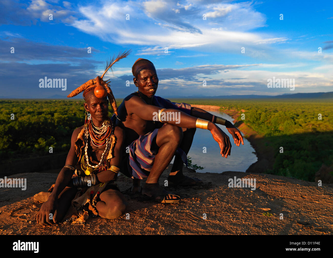 Portrait Of A Couple From Karo Tribe Over The Omo River At Sunset, Korcho Village, Ethiopia Stock Photo