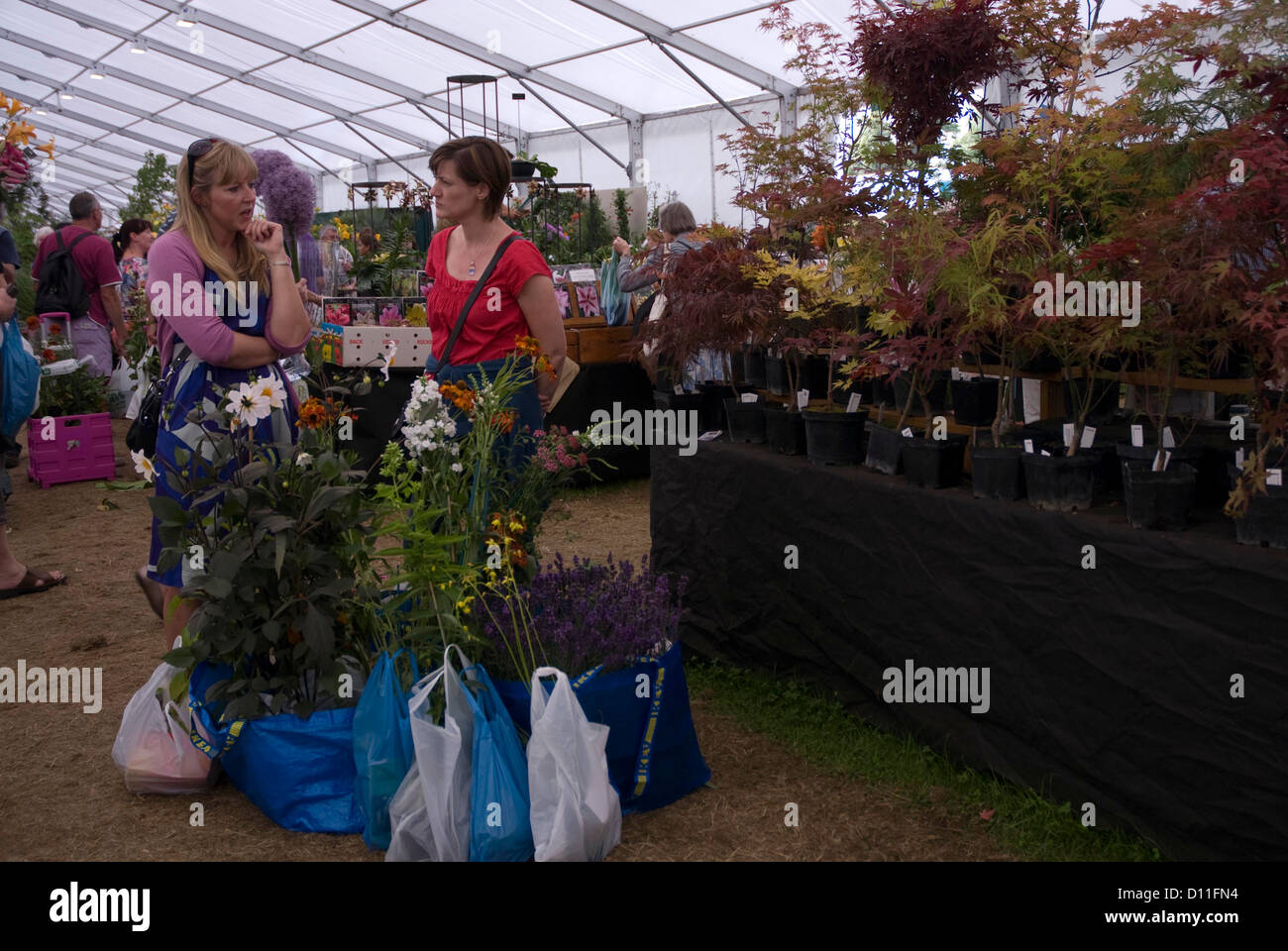 Women with purchases at the Hampton Court Flower Show, West London Stock Photo