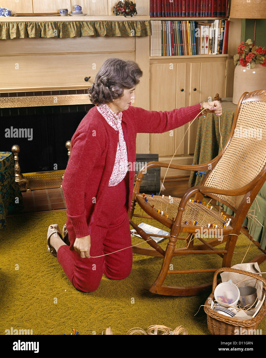1960s MIDDLE AGED WOMAN CANING CHAIR SEAT HOBBY REPAIR ART CRAFTS HOME HOUSEHOLD Stock Photo