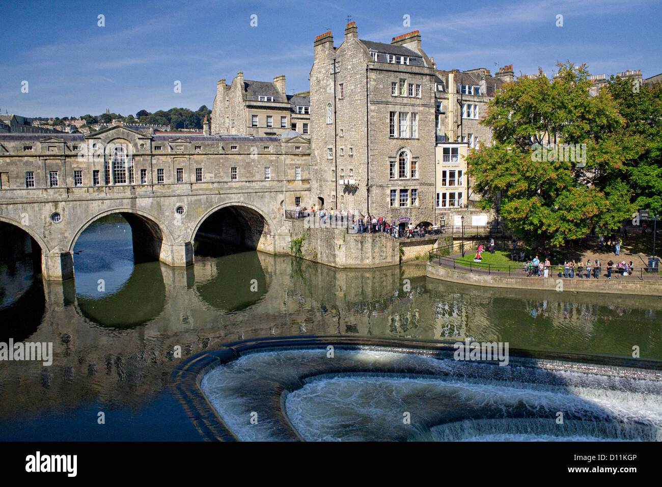 Pulteney Bridge over the River Avon, Bath England. A place for picnics and shopping for tourists visiting the city. Stock Photo
