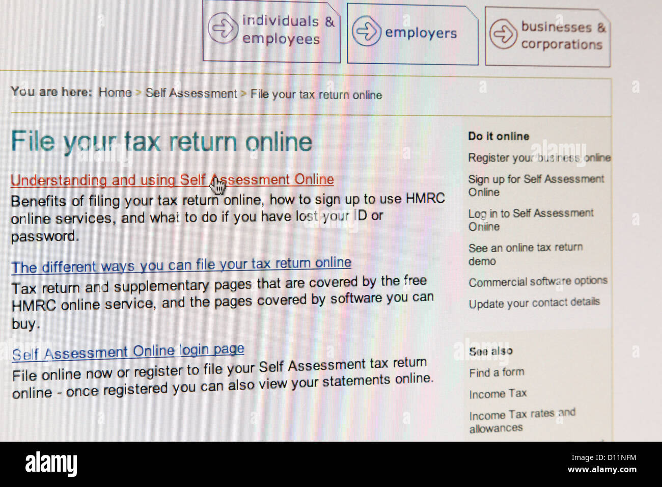 HM Revenue and Customs website page Self Assessment File your tax return online, hand pointing to Understanding and Using HMRC Stock Photo